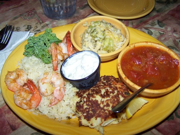 Barbara Jean's is known for their famous crab cakes. This is the crab cake and grilled shrimp over rice dinner with stewed tomatoes and broccoli & cheese casserole. 