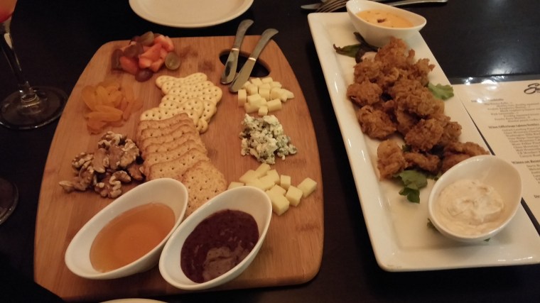 A beautiful cheese board (left) and cajun fried oysters (right).